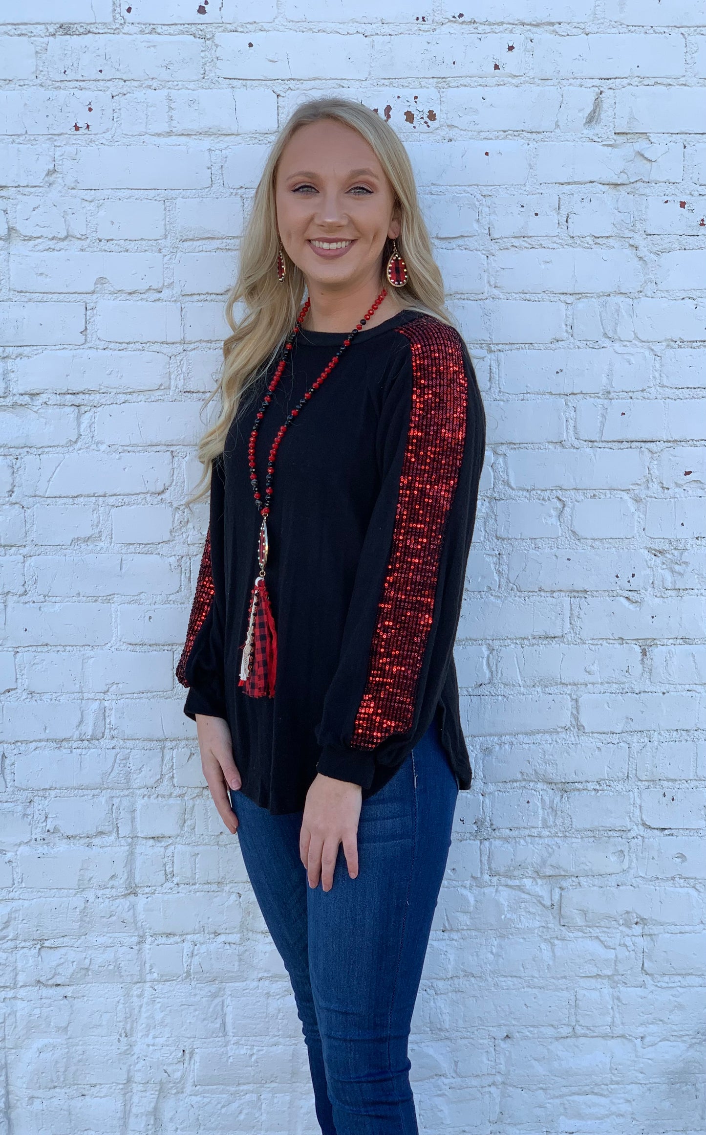 Black knit top with red sequin sleeves detail