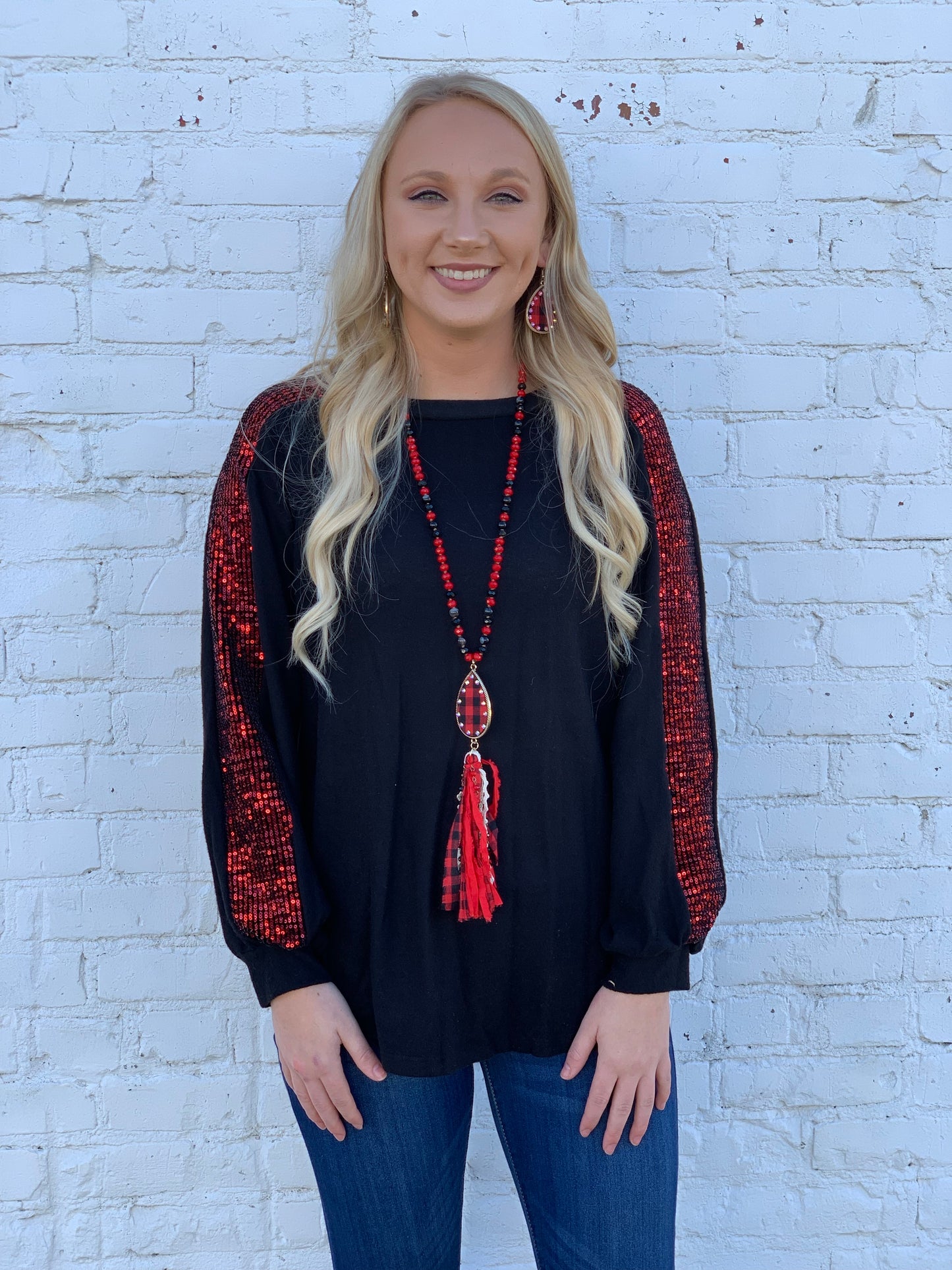 Black knit top with red sequin sleeves detail