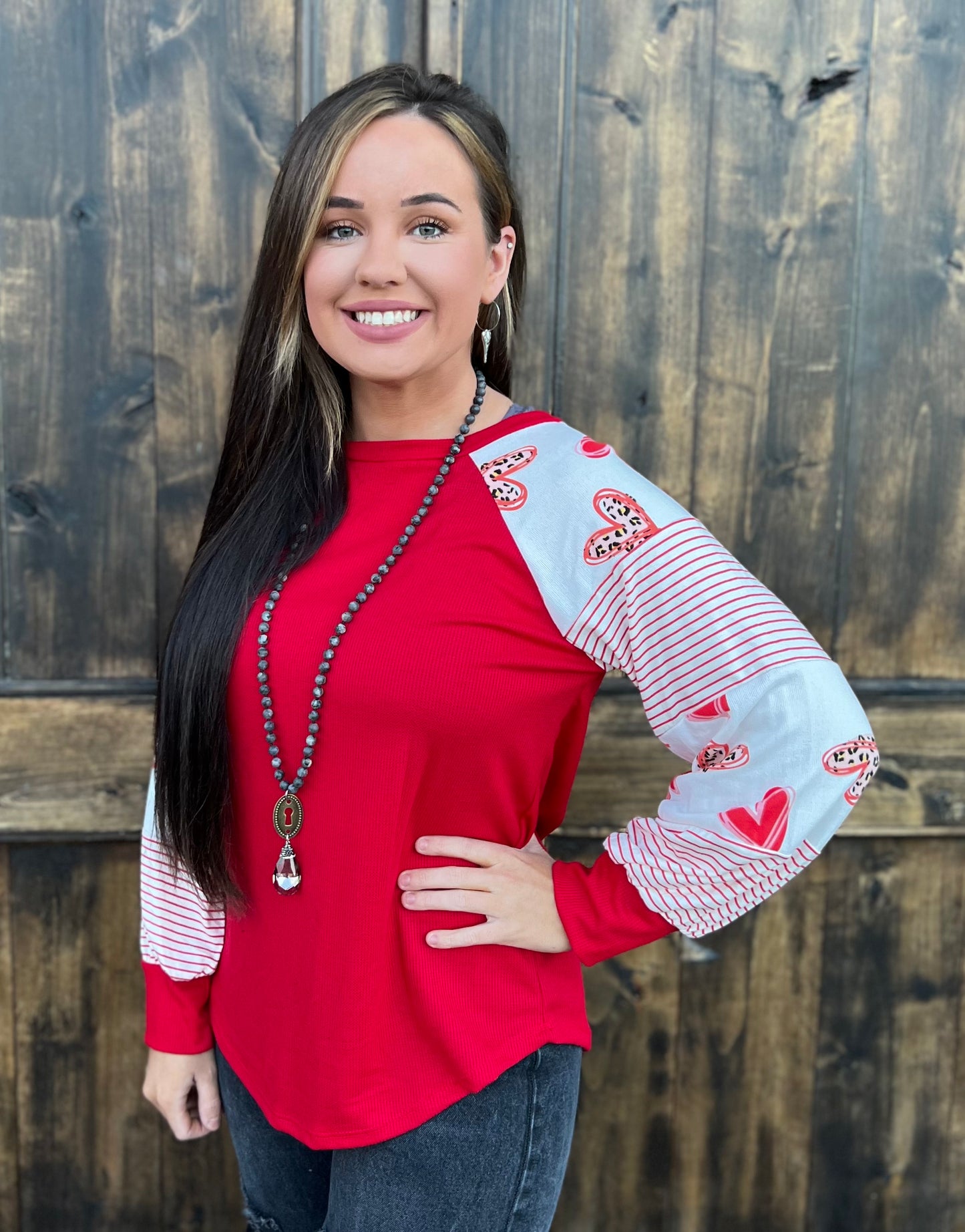Red top with heart colorblock sleeves